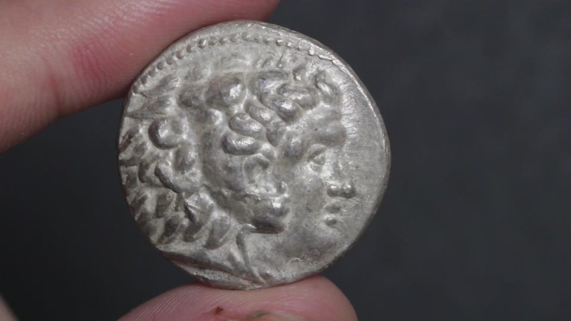 silent video of the alexander tetradrachm coin being rotated between two fingers