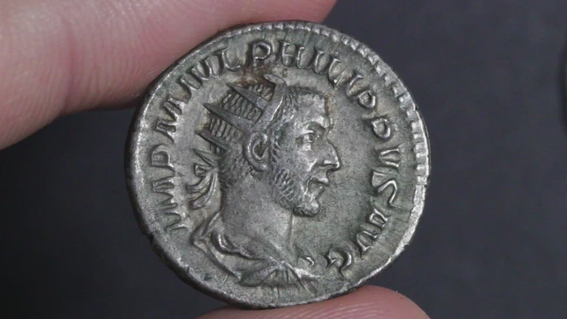 video showing the philip antoninianus being rotated between two fingers to show both sides