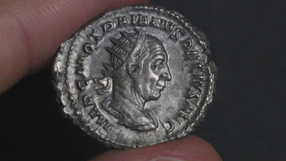 video of trajan decius antoninianus being rotated between two fingers to show both sides