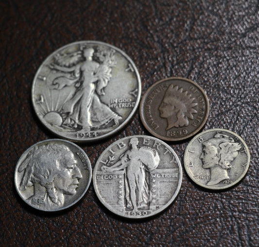 The obverse side of five old American coins next to each other, including a Walking Liberty half dollar, Standing Liberty quarter, Mercury dime, Buffalo nickel, and Indian head cent. 